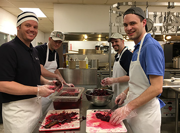 Staff from eDOC Innovations preparing food for the Hope center in Middlebury Vermont